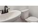 Bright bathroom features a stylish white sink and toilet, offering a minimalist and modern aesthetic at 5133 Aster Bnd, Canton, GA 30114