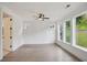 This light-filled bedroom features hardwood floors, neutral walls, and multiple windows with a view of a private backyard at 5133 Aster Bnd, Canton, GA 30114