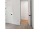 An unfinished bedroom shows the entrance with new white doors, baseboards, neutral walls and plush carpeting at 5133 Aster Bnd, Canton, GA 30114