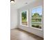 Bright interior space featuring hardwood flooring, large windows, and neutral paint at 5133 Aster Bnd, Canton, GA 30114