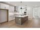 Modern kitchen featuring an island, stainless steel appliances, and white cabinetry at 5133 Aster Bnd, Canton, GA 30114