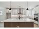 Modern kitchen featuring an island, stainless steel appliances, and white cabinetry at 5133 Aster Bnd, Canton, GA 30114