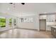 Spacious living area featuring hardwood floors, large windows, and modern lighting fixtures at 5133 Aster Bnd, Canton, GA 30114