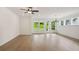 Spacious living area featuring hardwood floors, large windows, and modern lighting fixtures at 5133 Aster Bnd, Canton, GA 30114
