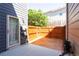 Cozy back patio with wood deck and privacy fence, perfect for outdoor relaxation and entertaining at 5715 Keys Way, Lithonia, GA 30058