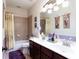 Bathroom featuring a double sink vanity, a tiled shower-tub combo, and soft, decorative accents at 5715 Keys Way, Lithonia, GA 30058