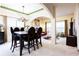 Traditional dining room with a chandelier, stylish table set, and an open-concept design into the living area at 5715 Keys Way, Lithonia, GA 30058
