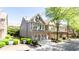 A lovely view of the townhome's facade, green lawn, and an attached two-car garage at 5715 Keys Way, Lithonia, GA 30058
