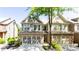 Charming townhome with stone accents, a two-car garage, and manicured landscaping at 5715 Keys Way, Lithonia, GA 30058