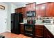 Well-equipped kitchen with granite countertops, dark wood cabinets, and stainless steel appliances at 5715 Keys Way, Lithonia, GA 30058
