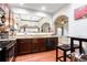 Beautiful kitchen with granite countertops, dark cabinets, and an open view to the dining area at 5715 Keys Way, Lithonia, GA 30058