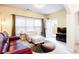 Cozy living room featuring a plush white armchair, a multi-colored rug, and natural light from the glass doors at 5715 Keys Way, Lithonia, GA 30058