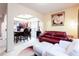 Comfortable living room with a red leather sofa, white ottoman, and views into the adjacent dining room at 5715 Keys Way, Lithonia, GA 30058