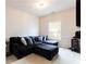 Comfortable living room featuring a plush, oversized black sectional sofa and a modern aesthetic at 5715 Keys Way, Lithonia, GA 30058