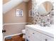 Elegant powder room featuring mosaic tile accents, a modern vanity, and stylish decorative wall art at 5715 Keys Way, Lithonia, GA 30058