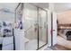 Modern bathroom featuring a spacious glass shower with decorative tiling and a vanity with open storage at 5715 Keys Way, Lithonia, GA 30058