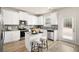 Modern kitchen with white cabinets, stainless steel appliances, central island with bar seating, and direct access to the backyard at 112 Maplewood Ln, Conyers, GA 30094