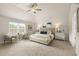 Spacious main bedroom with vaulted ceiling, large window, neutral colors, and a seating area for relaxing at 112 Maplewood Ln, Conyers, GA 30094