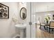 Tastefully decorated powder room with pedestal sink and stylish mirror, conveniently located near the dining area at 112 Maplewood Ln, Conyers, GA 30094
