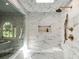 Elegant bathroom featuring marble tiling, glass shower enclosure, and luxurious fixtures at 302 Rolling Rock Se Rd, Marietta, GA 30067