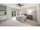 Bedroom with plush carpet, a ceiling fan and natural light from the picture window at 302 Rolling Rock Se Rd, Marietta, GA 30067