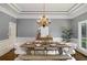 Formal dining room with a large wooden table, decorative chandelier and trey ceiling at 302 Rolling Rock Se Rd, Marietta, GA 30067