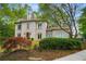 Charming gray home surrounded by lush landscaping, creating a serene curb appeal at 302 Rolling Rock Se Rd, Marietta, GA 30067