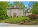 Stately two-story home with a manicured lawn, and lush landscaping at 302 Rolling Rock Se Rd, Marietta, GA 30067