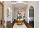 Elegant foyer featuring hardwood floors, arched doorways and a light gray color palette at 302 Rolling Rock Se Rd, Marietta, GA 30067