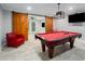 Red pool table featured in spacious game room with adjoining space featuring sliding barn doors at 302 Rolling Rock Se Rd, Marietta, GA 30067