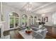 Spacious living room with floor to ceiling windows, hardwood floors and modern decor at 302 Rolling Rock Se Rd, Marietta, GA 30067