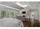 Comfortable main bedroom offers a sitting area, fireplace, and ample natural light at 302 Rolling Rock Se Rd, Marietta, GA 30067