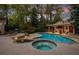 Stunning backyard pool area with a hot tub, outdoor seating, and lush landscaping at 302 Rolling Rock Se Rd, Marietta, GA 30067