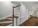Elegant staircase with hardwood steps and decorative banister detailing at 302 Rolling Rock Se Rd, Marietta, GA 30067