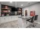 Entertain in this finished basement wet bar, complete with flat-screen TV, custom shelving, and mini fridge at 302 Rolling Rock Se Rd, Marietta, GA 30067
