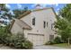 Side view of the home showing the attached garage and neutral siding at 3241 Adams St, Atlanta, GA 30337