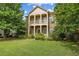 Charming two-story brick home with a covered porch and a well-manicured lawn at 3241 Adams St, Atlanta, GA 30337