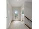 Well-lit hallway features carpeted floor and a door leading to the outside with railing on the stairs at 3241 Adams St, Atlanta, GA 30337