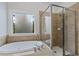Luxurious main bathroom with soaking tub and glass-enclosed shower, and a window for natural light at 3241 Adams St, Atlanta, GA 30337