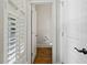 Convenient powder room featuring wood floors, white walls, and a standard toilet, accessible from hallway at 3241 Adams St, Atlanta, GA 30337