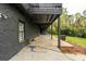 Covered back patio with concrete flooring and views of the backyard and lower level at 5254 Greenpoint Dr, Stone Mountain, GA 30088