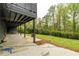 Covered back patio with concrete flooring, columns, and lush greenery beyond at 5254 Greenpoint Dr, Stone Mountain, GA 30088