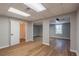 Large finished basement with multiple rooms, wood-look flooring, and neutral paint at 5254 Greenpoint Dr, Stone Mountain, GA 30088