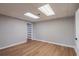Finished basement area with wood-look flooring, painted block walls, and bonus storage space at 5254 Greenpoint Dr, Stone Mountain, GA 30088
