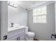 Updated bathroom with gray vanity, white countertop, and modern fixtures at 5254 Greenpoint Dr, Stone Mountain, GA 30088