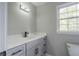 Bathroom with a modern vanity, black faucet, white countertop, and a large mirror at 5254 Greenpoint Dr, Stone Mountain, GA 30088