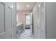 Bathroom with marble floors, gray cabinets and a view from the window at 5254 Greenpoint Dr, Stone Mountain, GA 30088
