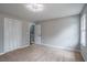 Bright, carpeted bedroom with a closet, neutral paint, and a modern light fixture at 5254 Greenpoint Dr, Stone Mountain, GA 30088