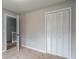 Carpeted bedroom with closet featuring bi-fold doors and view of the staircase at 5254 Greenpoint Dr, Stone Mountain, GA 30088