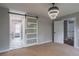 Bedroom featuring a barn door, contemporary lighting, and doorway into a hallway at 5254 Greenpoint Dr, Stone Mountain, GA 30088